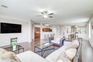 a living room with a couch and a table at Houston Retreat with Pool Access and Fenced-In Yard! in Houston
