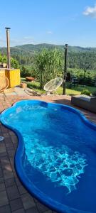a large blue swimming pool on a patio at Chata w Grapie in Koniaków