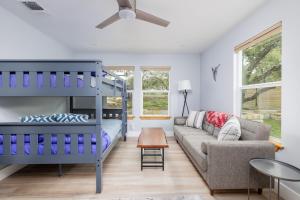 a living room with a bunk bed and a couch at Casa Mariposa Newly Renovated Firepit*Fireplace*Great Deck*Pets Welcome! in Bee Cave