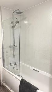 a shower with a glass door in a bathroom at Spacious City Centre flat free parking& superfast WIFI in Edinburgh +20 photos