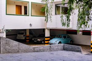 a car garage with two cars parked in it at Hotel Primavera Betim in Betim +46 photos