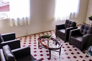 a living room with couches and a coffee table at Hotel Primavera Betim in Betim