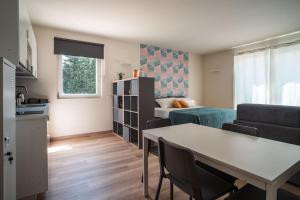 a living room with a couch and a table at Monolocale Moderno Valpolicella Verona - Jala in San Pietro in Cariano