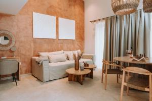 a living room with a couch and a table at Gabbana Beach Villas in Syvota +42 photos