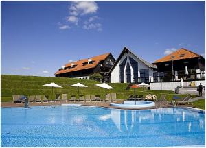 a large swimming pool in front of a house at Siedlisko Morena in Stare Juchy