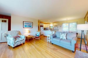 a living room with a couch and a chair at Lobster Tail Cottage in Castine