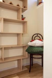 a chair with a pillow on it in a room at Dimora Moscato Reale in Trani