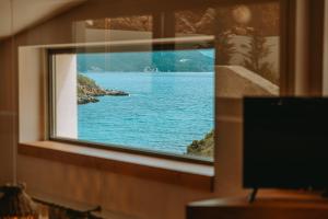 a view of a lake from a window at Gabbana Beach Villas in Syvota