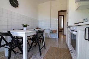 a kitchen with a table and some chairs in it at 256 - Casa San Bernardo Vista Mare, nel verde di Sestri Levante in Sestri Levante