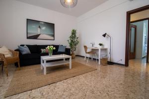 a living room with a couch and a table at 256 - Casa San Bernardo Vista Mare, nel verde di Sestri Levante in Sestri Levante
