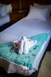 a towel with a stuffed animal on a bed at Bianchi Hotel in Alexandria