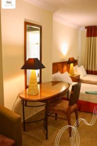 a hotel room with a table and a bed at Bianchi Hotel in Alexandria