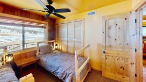 a bedroom with a bunk bed and a window at Pack Creek ~ Farm House in Moab +46 photos