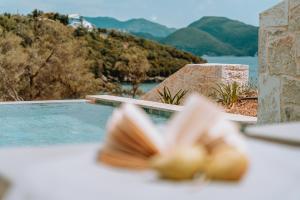 a close up of a shell on a table next to a swimming pool at Gabbana Beach Villas in Syvota