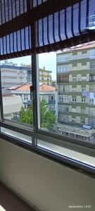 a window with a view of a large building at Apartamento Varanda do Sol in Amora