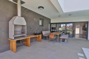 a kitchen with an oven and a table with chairs at Villa Anna in Premantura