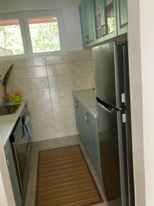 a kitchen with a refrigerator and a wooden floor at Apartment Seaside bay in Herceg-Novi