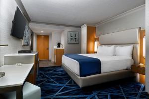 a hotel room with a bed and a kitchen at The STRAT Hotel, Casino & Tower in Las Vegas