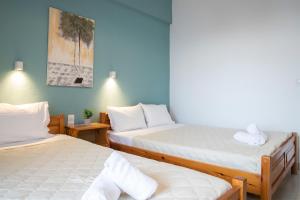 A bed or beds in a room at Manos Kritikakis Apartments