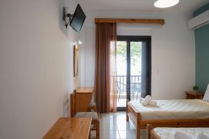 A bed or beds in a room at Manos Kritikakis Apartments