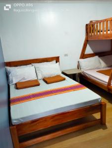 a bedroom with two bunk beds in a room at Baguio Dreamz - Transient in Baguio