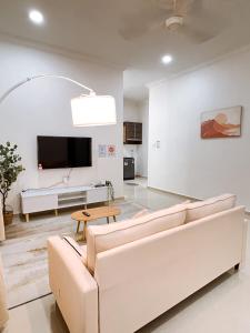 a living room with a couch and a tv at Ar-Rayyan 2 Homestay Kota Bharu in Kota Bharu