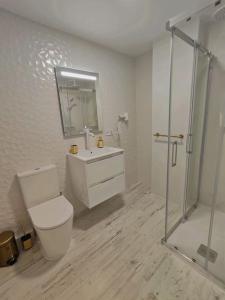 a white bathroom with a toilet and a shower at El mirador de La Concha in Oropesa del Mar +28 photos