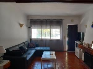 a living room with a couch and a table at Casa Kunkapi in Portimão