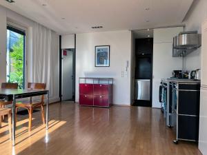 a kitchen with a table and a dining room at Marina Studio Bregenz - See & City in Bregenz