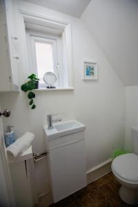 bagno bianco con lavandino e servizi igienici di Granby Grove Townhouse - Sleeps 8- 4 Bedrooms a Southampton