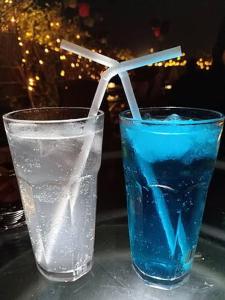 a glass of water with a drinking straw on a table at Shree R.C.VATIKA in Motīhāri