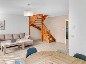 a living room with a couch and a table at Limoges, résidence fermée, 3 chambres, piscine, parking, 6 pers in Limoges +20 photos