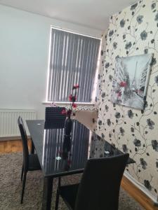 a dining room with a table and a window at Carfax House in Manchester