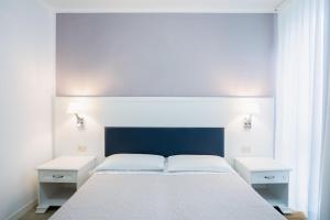 Postel nebo postele na pokoji v ubytování Hotel Il Caravaggio