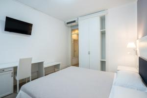 Postel nebo postele na pokoji v ubytování Hotel Il Caravaggio