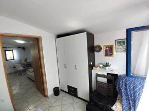 a room with a white cabinet and a dining room at Santorini by Jasna in Vir
