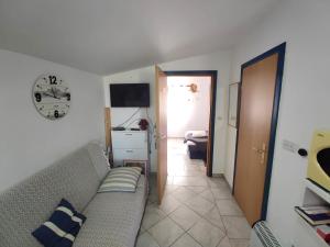 a living room with a couch and a hallway at Santorini by Jasna in Vir
