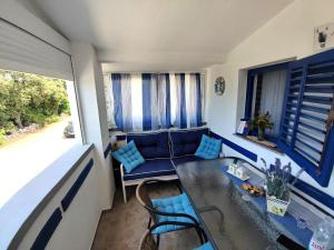 a living room with a couch and a table at Santorini by Jasna in Vir