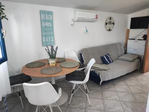 a table and chairs in a living room with a couch at Santorini by Jasna in Vir