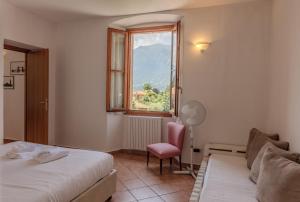 a hotel room with two beds and a window at Appartamenti Villa Giulia in Bellagio