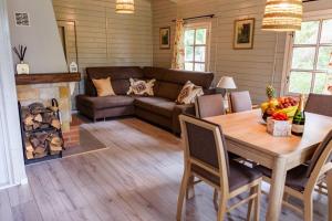 Una sala de estar con una mesa de madera y un sofá. en Zacisze u Ani, en Dębki