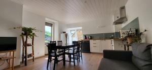 a kitchen and dining room with a table and chairs at La Louve in Arbois