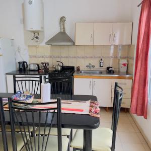 eine Küche mit Tisch und Herd oberen Backofen in der Unterkunft G2 Casa en Villa Ángela 2 dormitorios con Garage Independiente in Villa Ángela