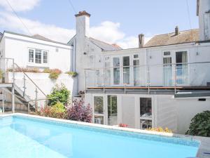 a house with a swimming pool in front of a house at Topside in Salcombe