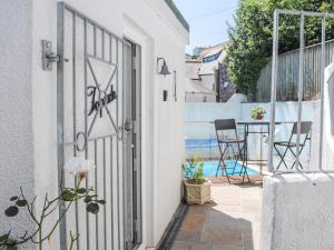 an open door to a patio with a table and chairs at Topside in Salcombe