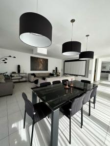 a living room with a dining table and chairs at Paradies in den Bergen nahe Garmisch Partenkirchen in Eschenlohe