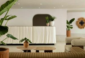 a living room with a table and potted plants at Sandbourne Santa Monica, Autograph Collection in Los Angeles +124 photos