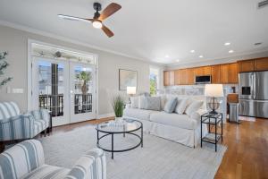 a living room with a couch and a table at Lowcountry State of Mind luxury beach getaway located on Harbor Island, South Carolina in St. Helena Island