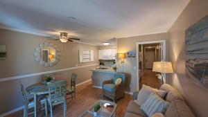 a living room and kitchen with a couch and a table at Ocean Dunes Villas in Hilton Head Island