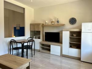 a kitchen with a table and a refrigerator and a dining room at Loft 'Sol y Sal' Apartamento en primera linea de playa in Miami Platja +10 photos